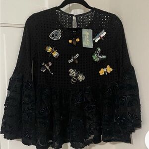 Dor Dor Couture black mesh top with bell sleeves and embroidered bug appliqués.